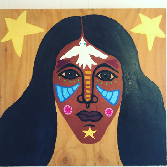 A colorful painted portrait of a woman's face on a light wood background, with large yellow stars in the upper corners, dark hair, blue eye details, pink cheek flowers, and a white dove above the forehead.