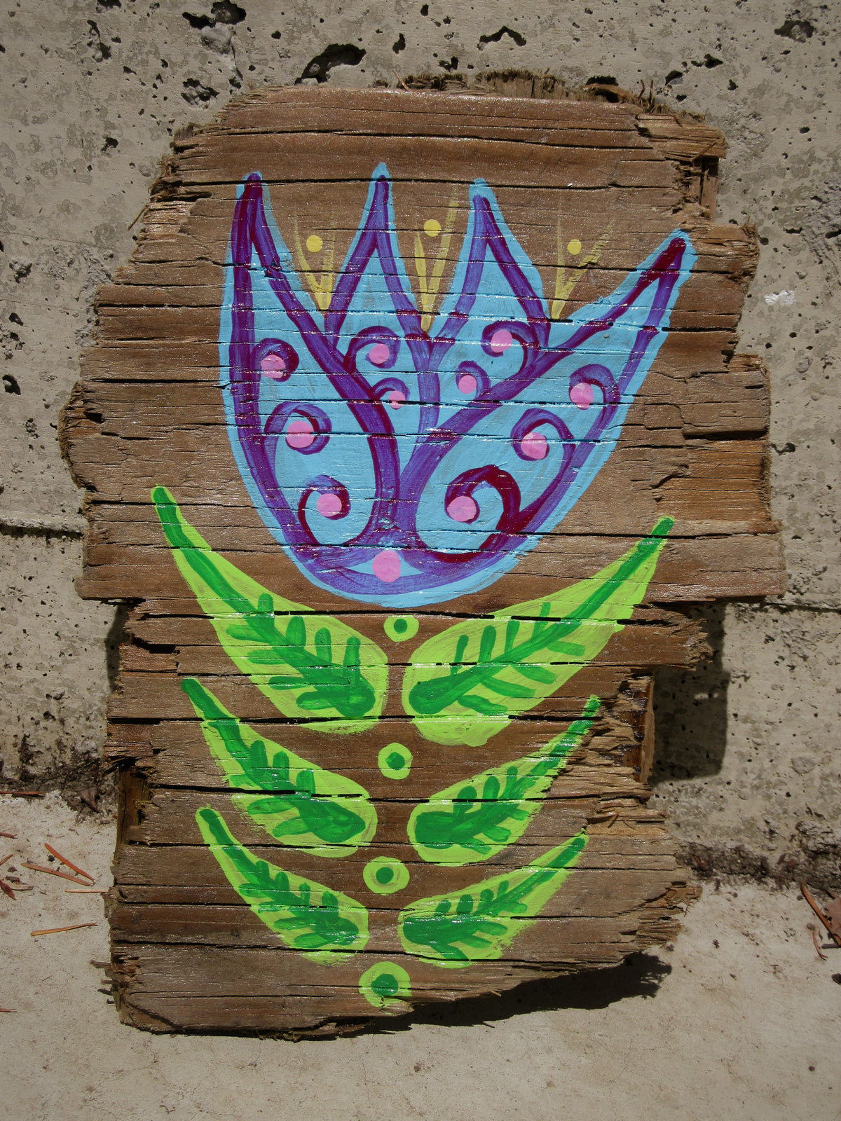 Folk art tulip painted on weathered wood by Lone Peep: blue and purple bloom with green leaves.