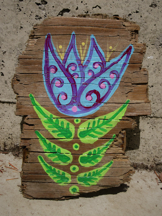 Folk art tulip painted on weathered wood by Lone Peep: blue and purple bloom with green leaves.