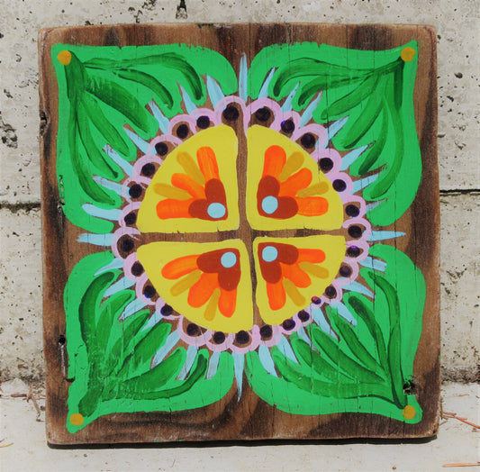 Folk art flower painted on a dark wood board by Lone Peep: yellow-orange bloom with green leaves and pink dotted border.