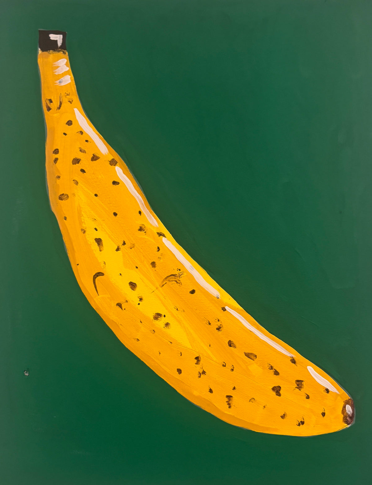 A painted yellow banana with brown speckles on a solid dark green background.